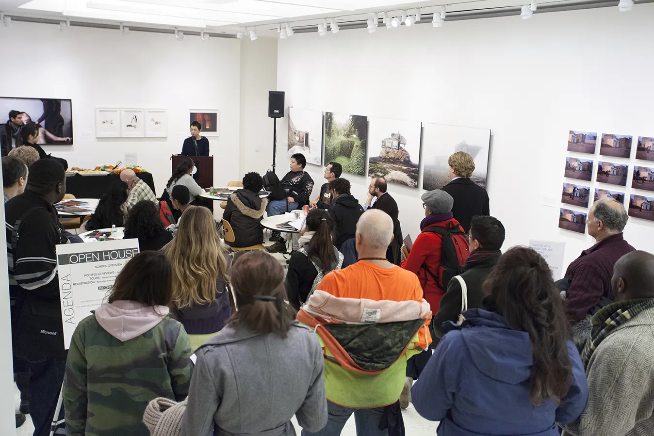 A photo of a group of people watching a presentation.